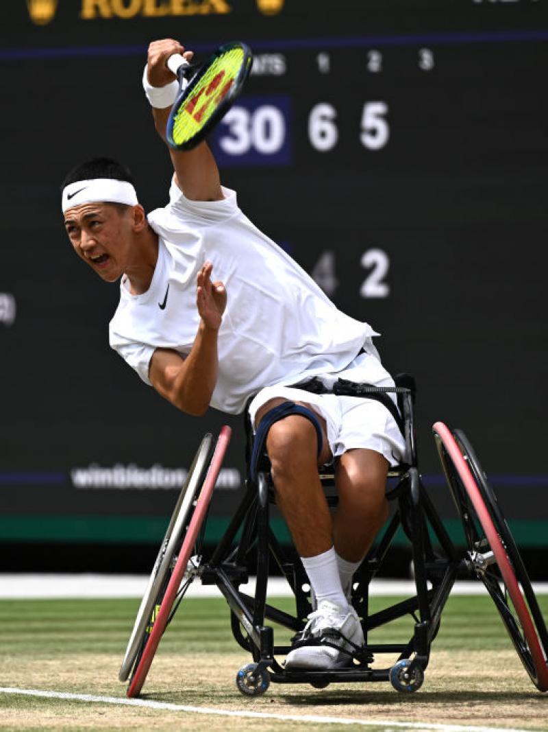 A male wheelchair tennis player competes