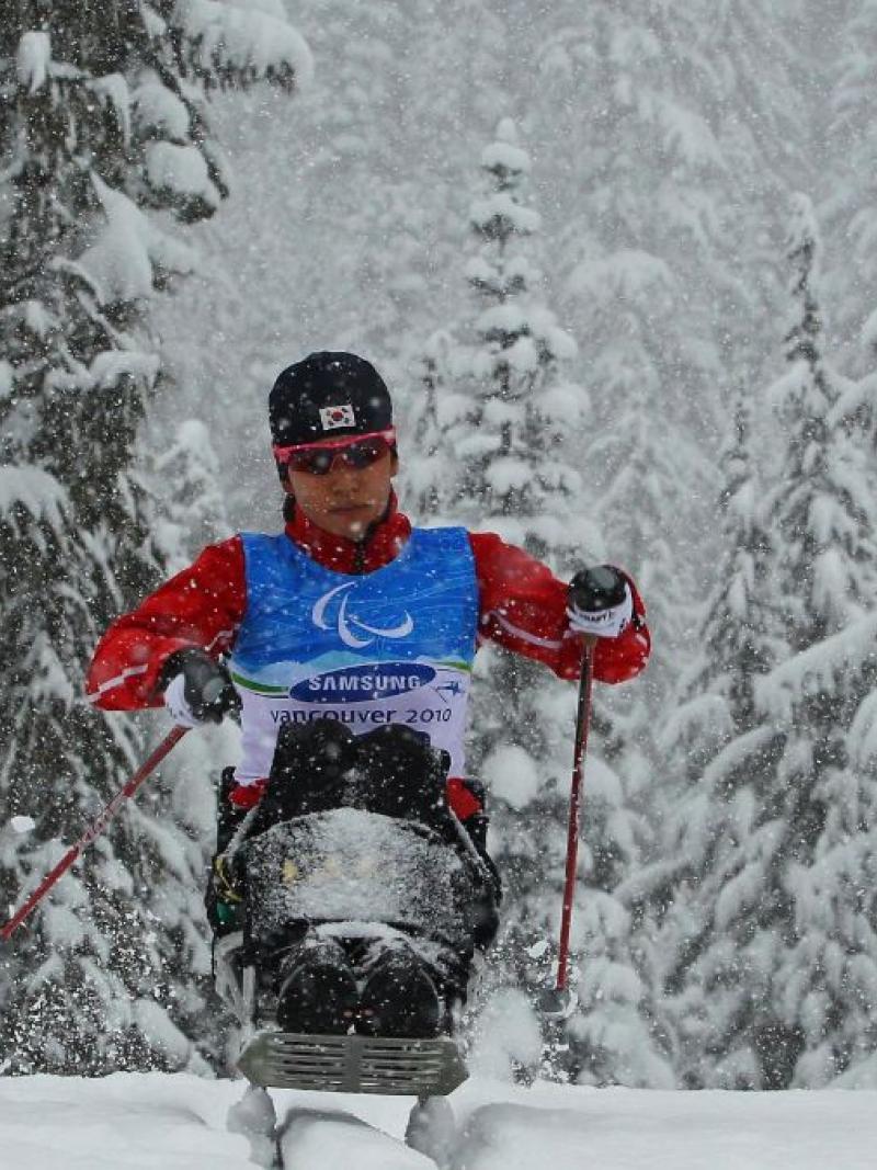 A female sit-skier competes at the Vancouver 2010 Paralympic Winter Games