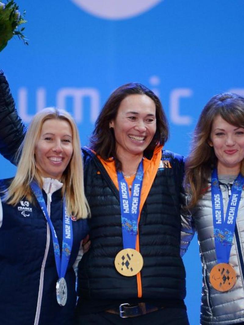 three female Para snowboarders on the podium