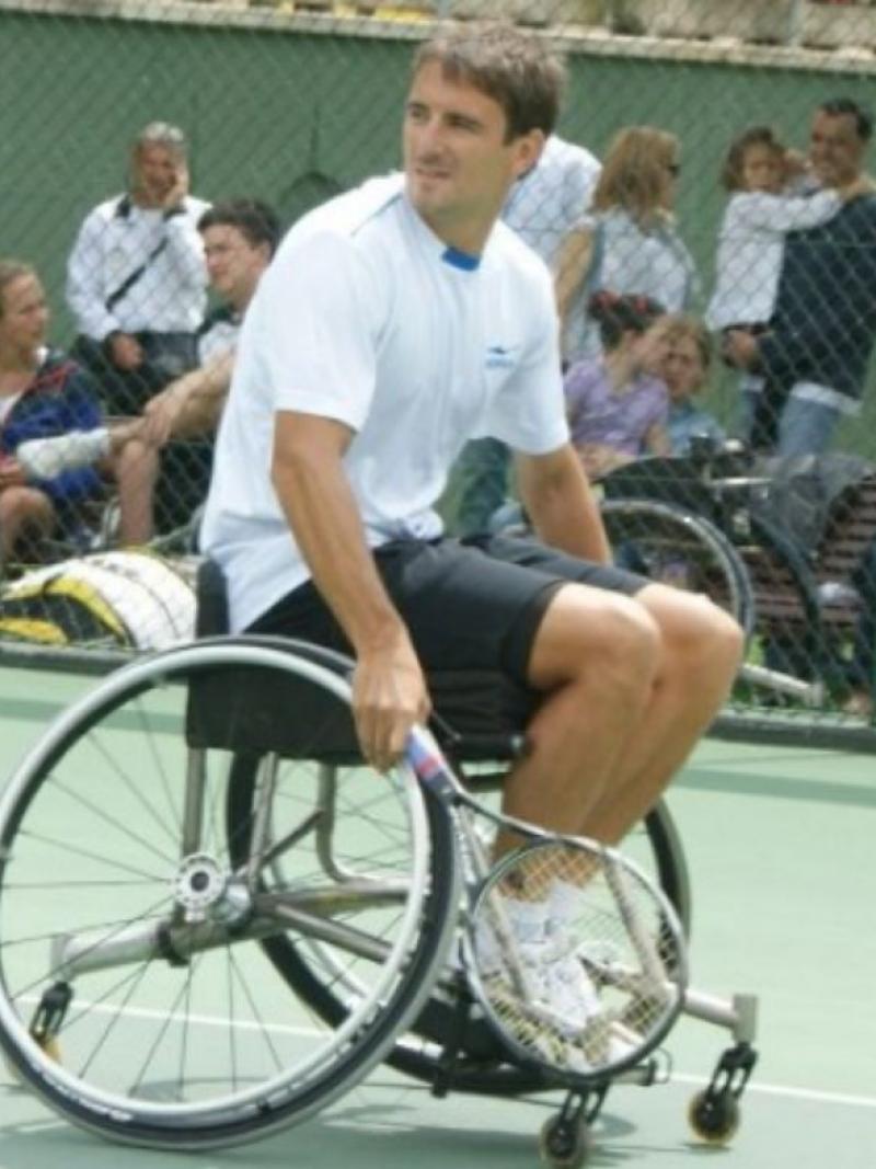 male tennis player Tommy Robredo in a wheelchair on the court