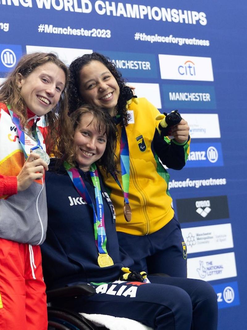 Three female athletes on a podium 