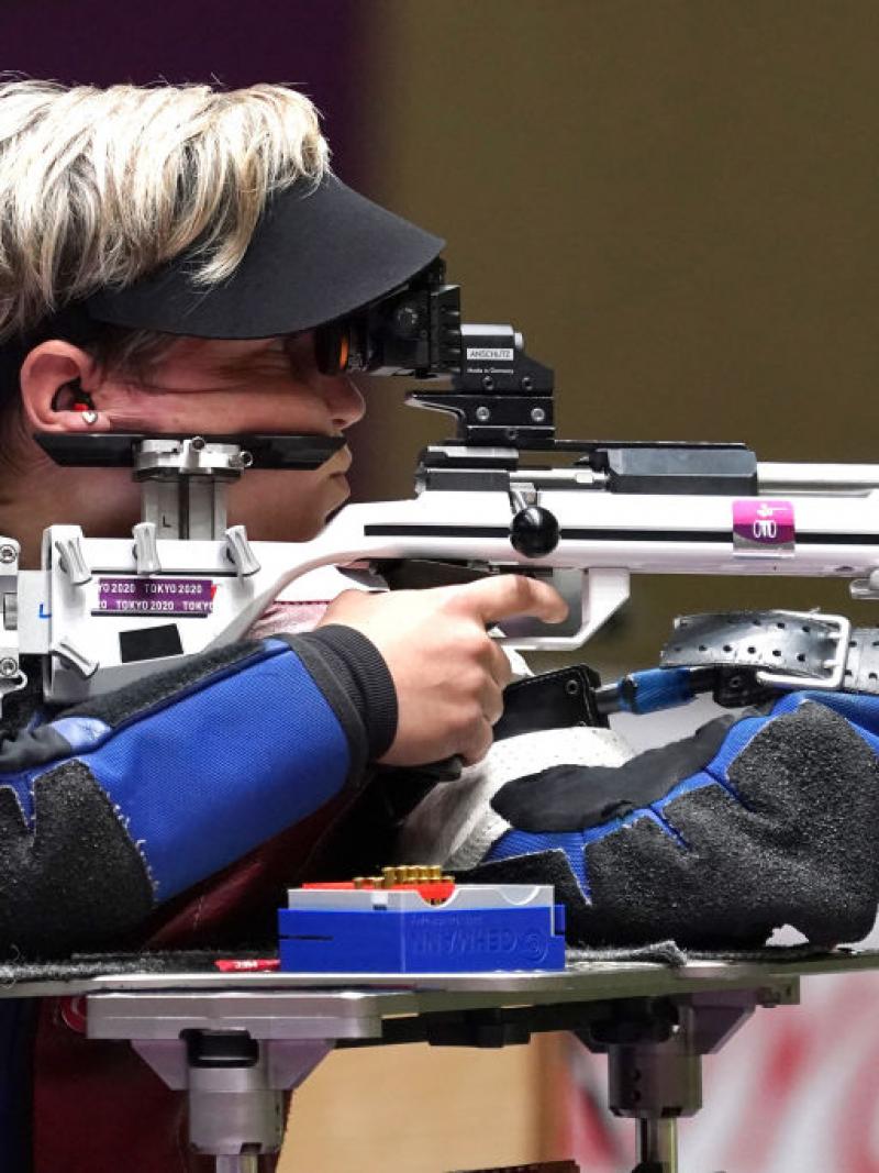 A female athlete competing in a shooting rifle event