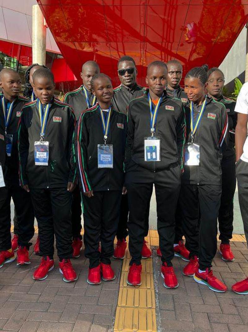 a group of Kenyan Goalball players smiling with their coach