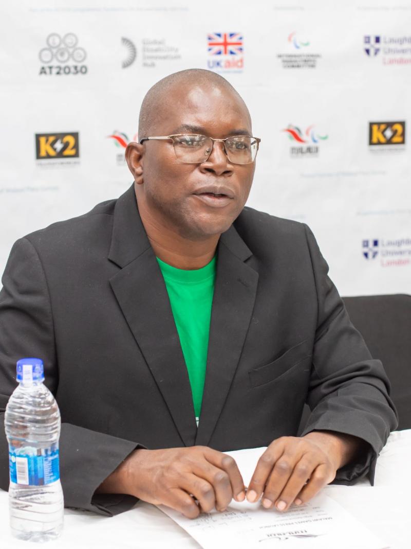 a man in glasses speaking at a press conference 