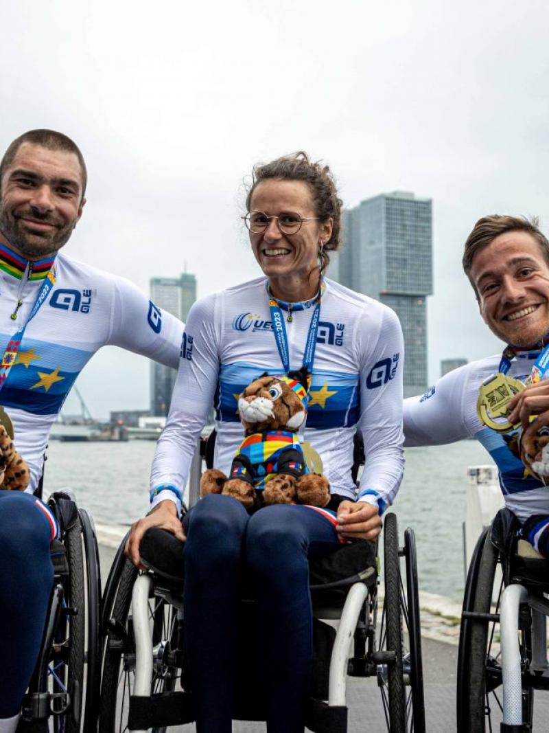 Three Para athletes posing for a photo after receiving gold medals and a European champion shirt