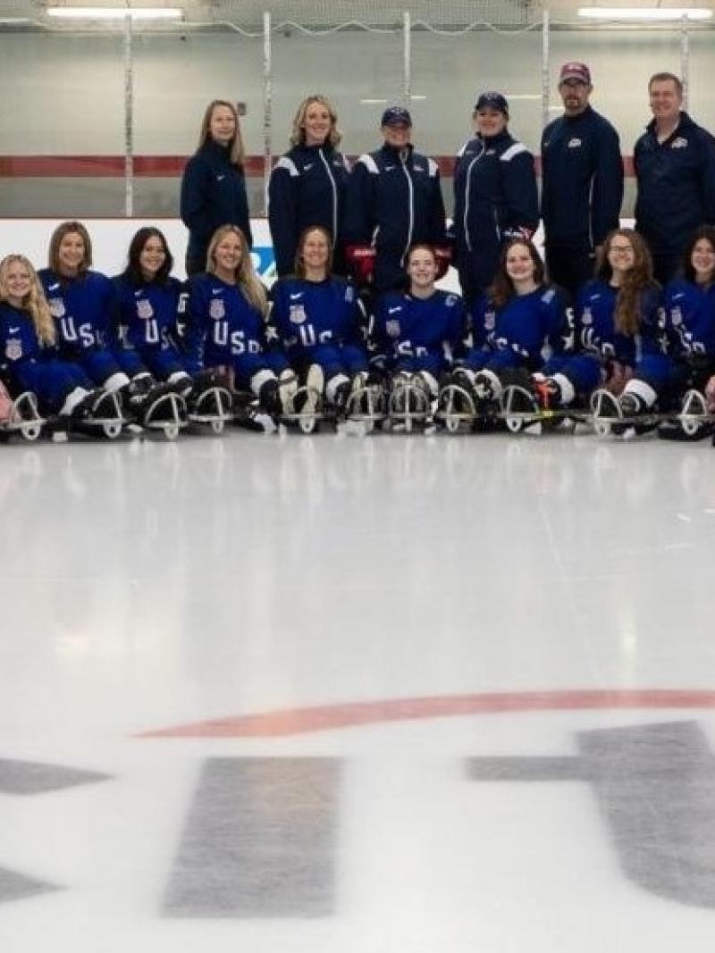 The USA women's Para ice hockey national team in a team picture on an ice rink
