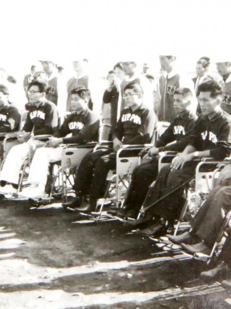 Japanese atheltes in a row listening