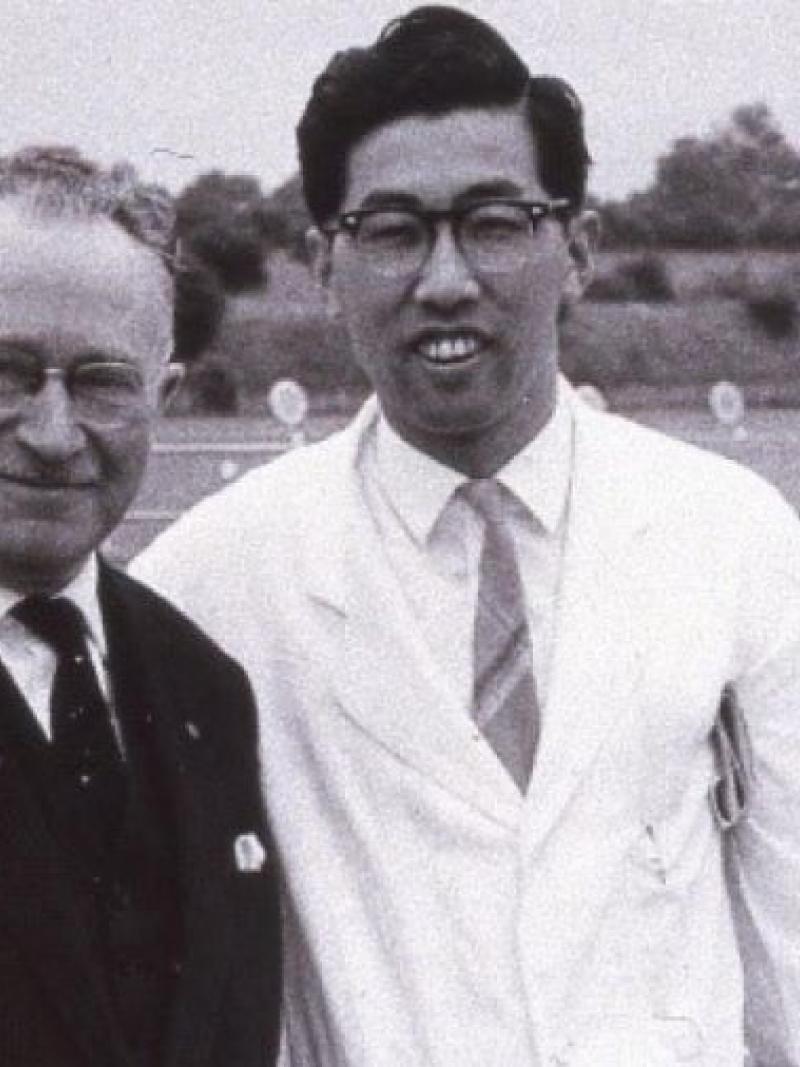 Black and white photo of Japanese man posing with Sir Ludwig Guttman 