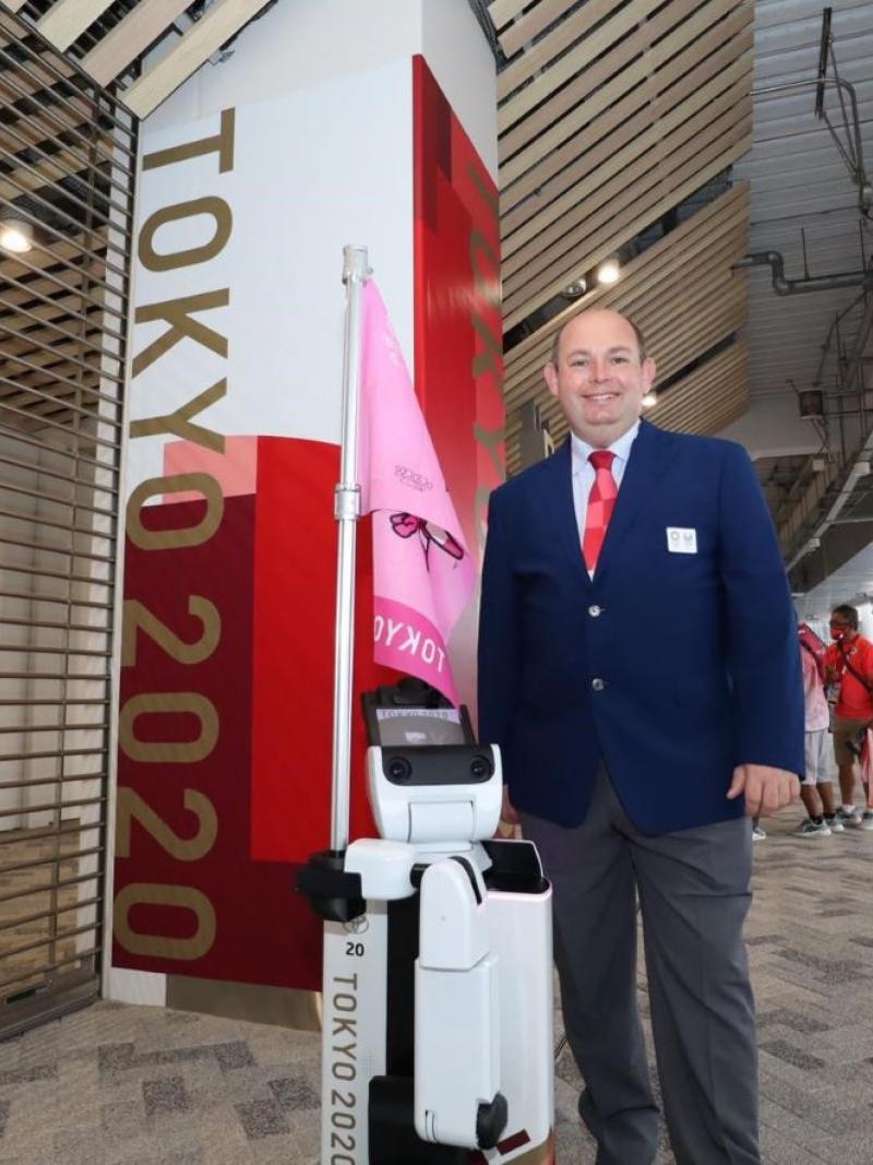 A man wearing a suit standing in the external area of a stadium