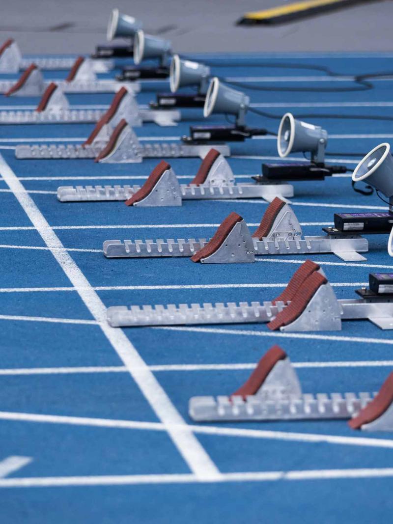 The starting blocks on a blue athletics track
