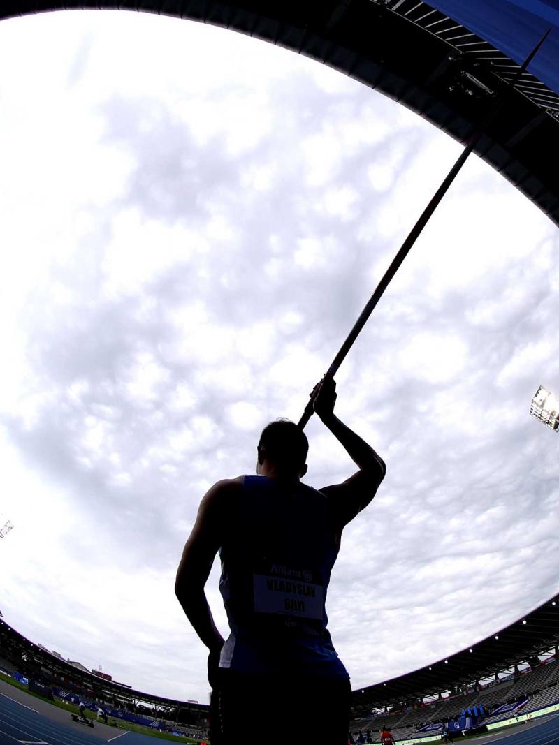 A male javelin thrower in a athletics stadium