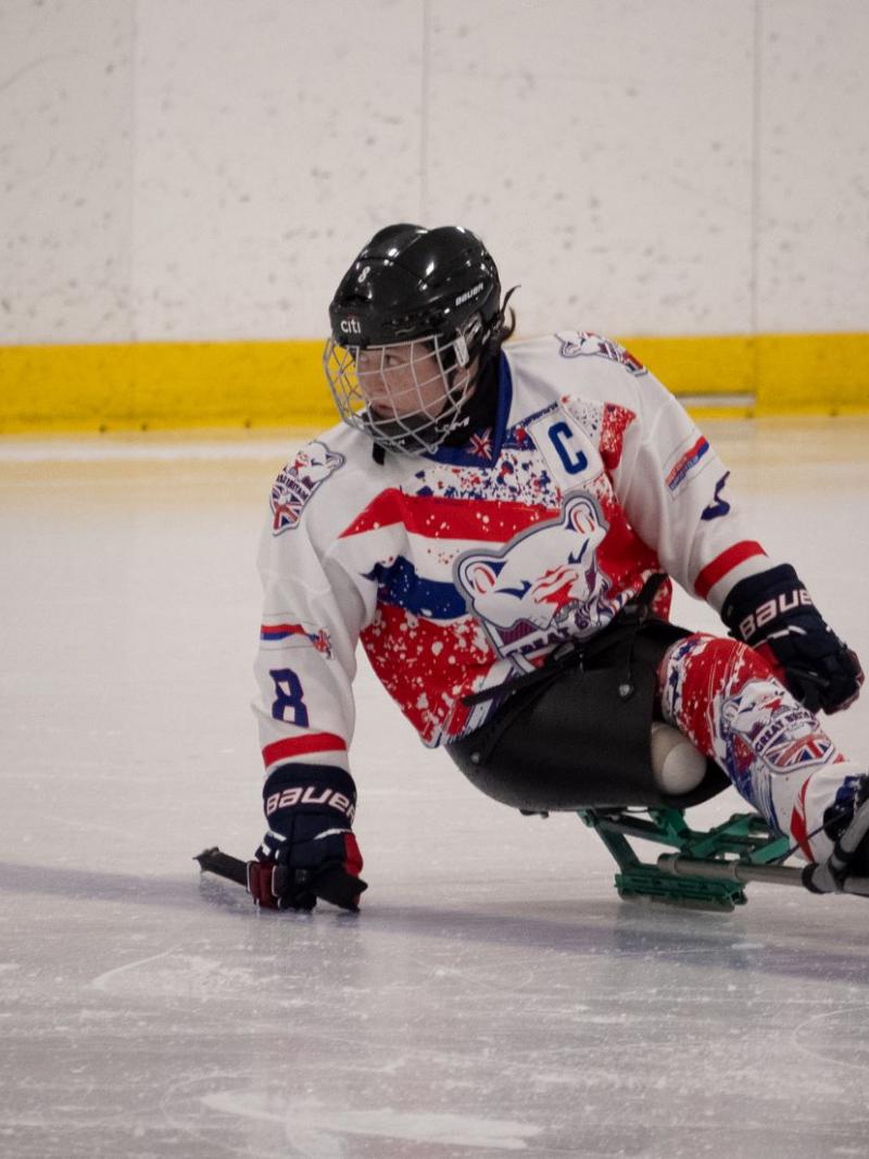 A female Para ice hockey player on ice
