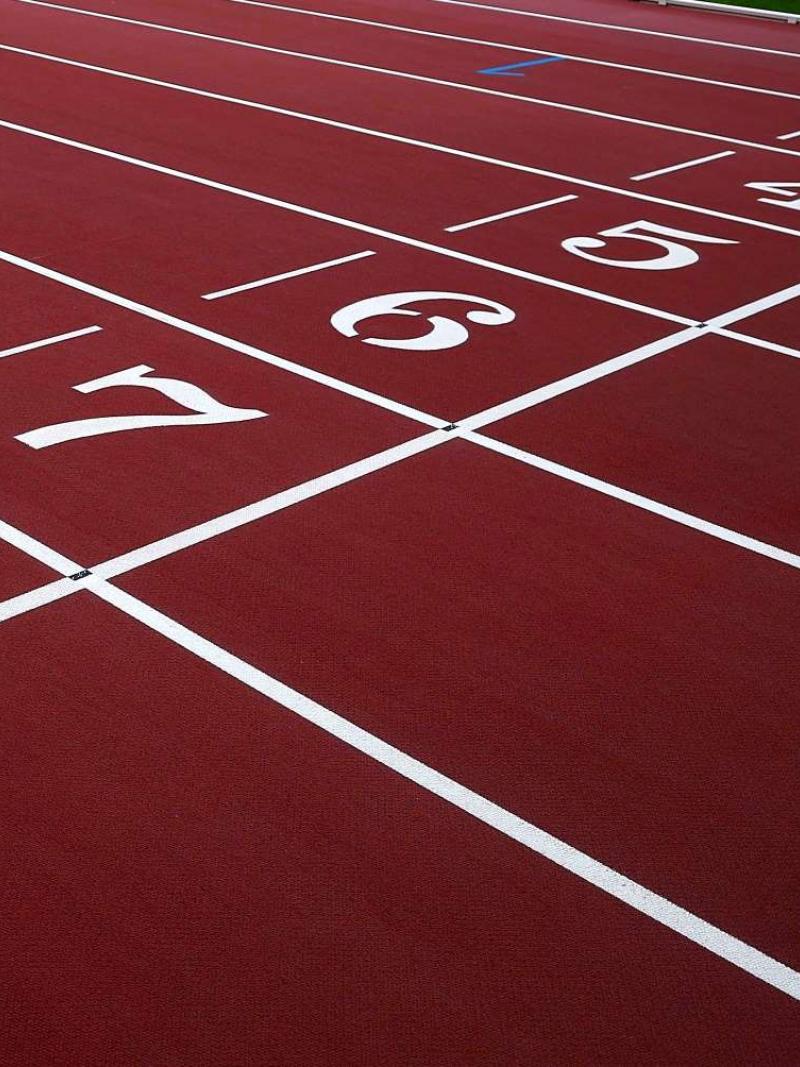 The finish line of a red athletics track