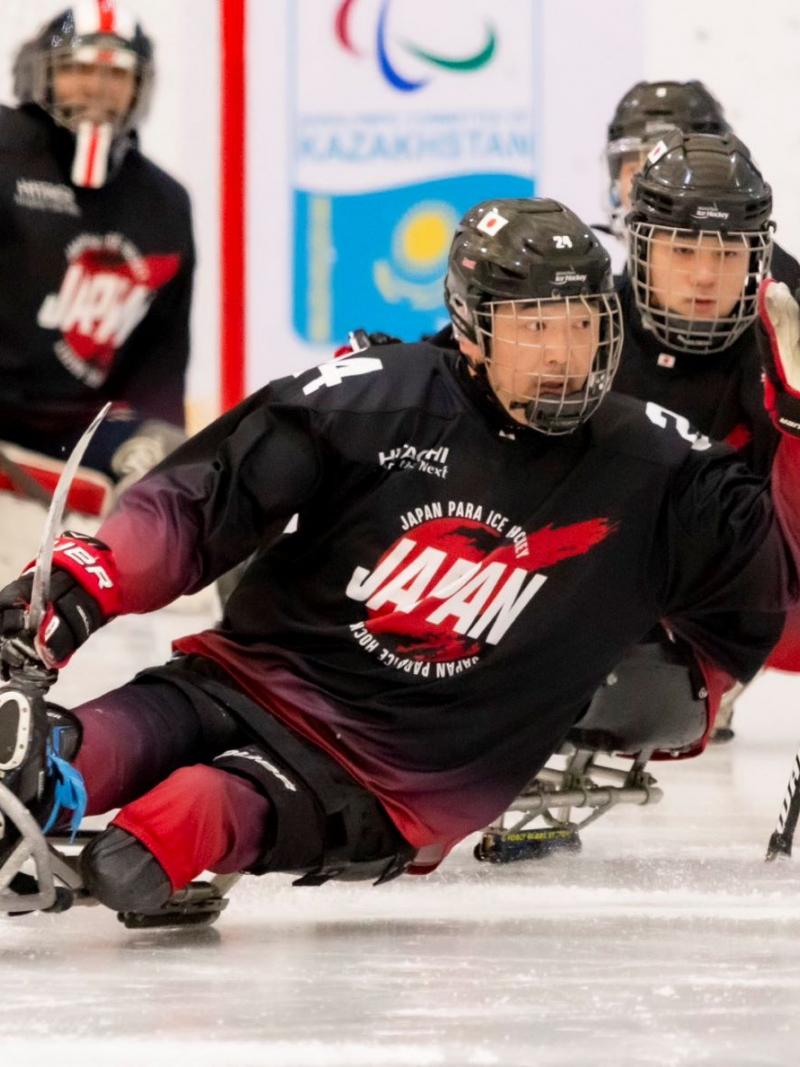 Three Japanese Para ice hockey players during a game