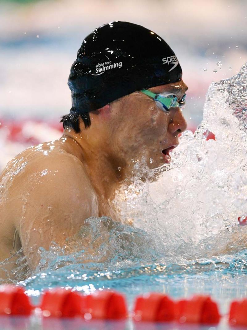 A male swimmer in a breaststroke race