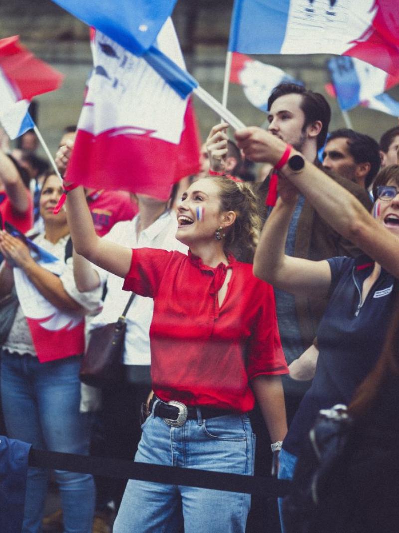 French fans waving flags in Paris.
