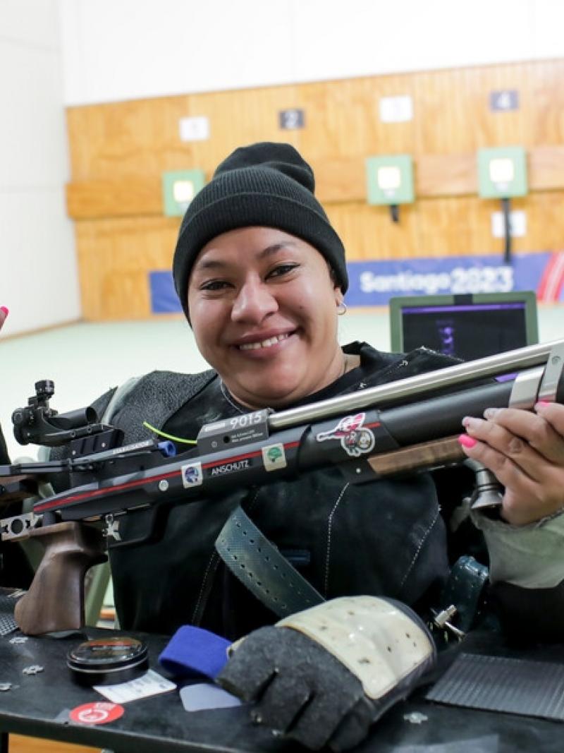A female Para athlete with a rifle in a shooting range