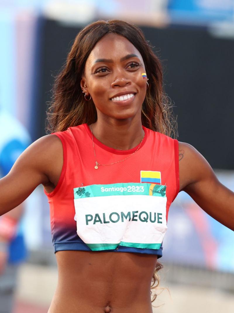 A female athlete from Colombia celebrates after a win by pumping her fists