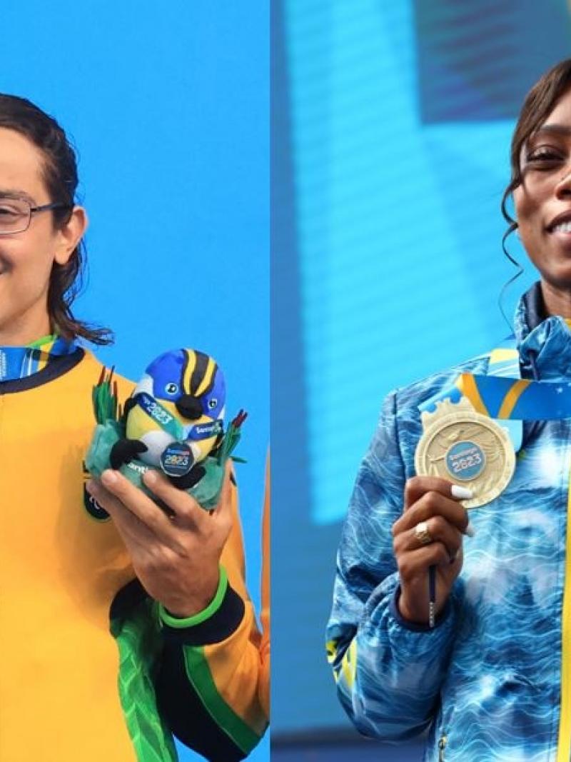 A man and a woman on the podium showing their gold medals