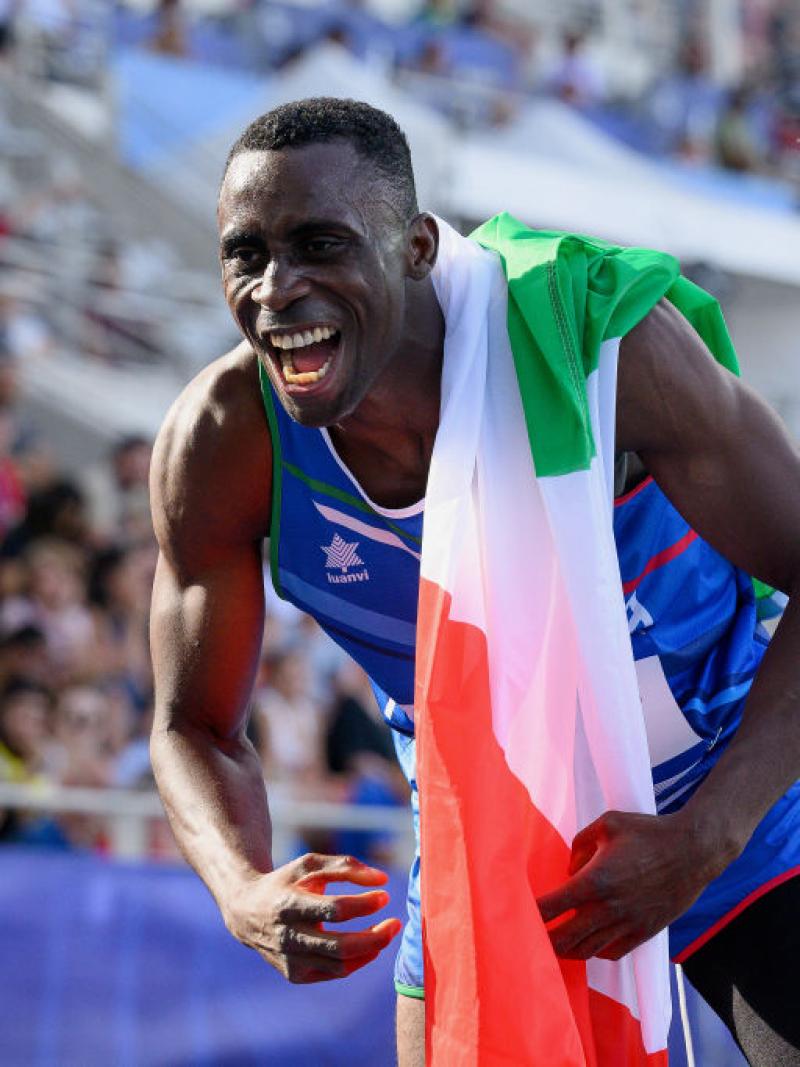 A male athlete celebrates after a win.