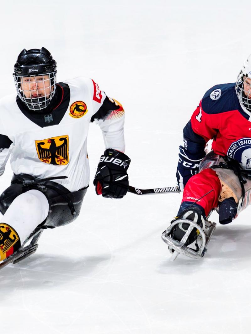 Two male Para ice hockey players from Germany and Norway on ice