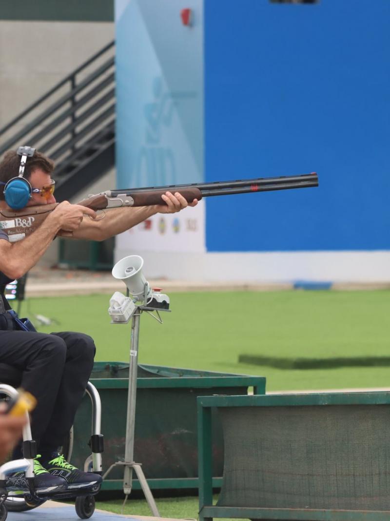 A man in a wheelchair competing in a Para trap event