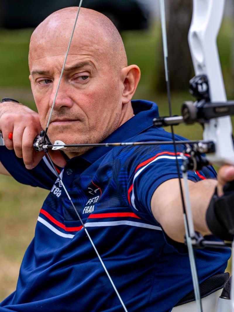 French Para archer Damien Letulle is preparing to shoot an arrow during competition. 