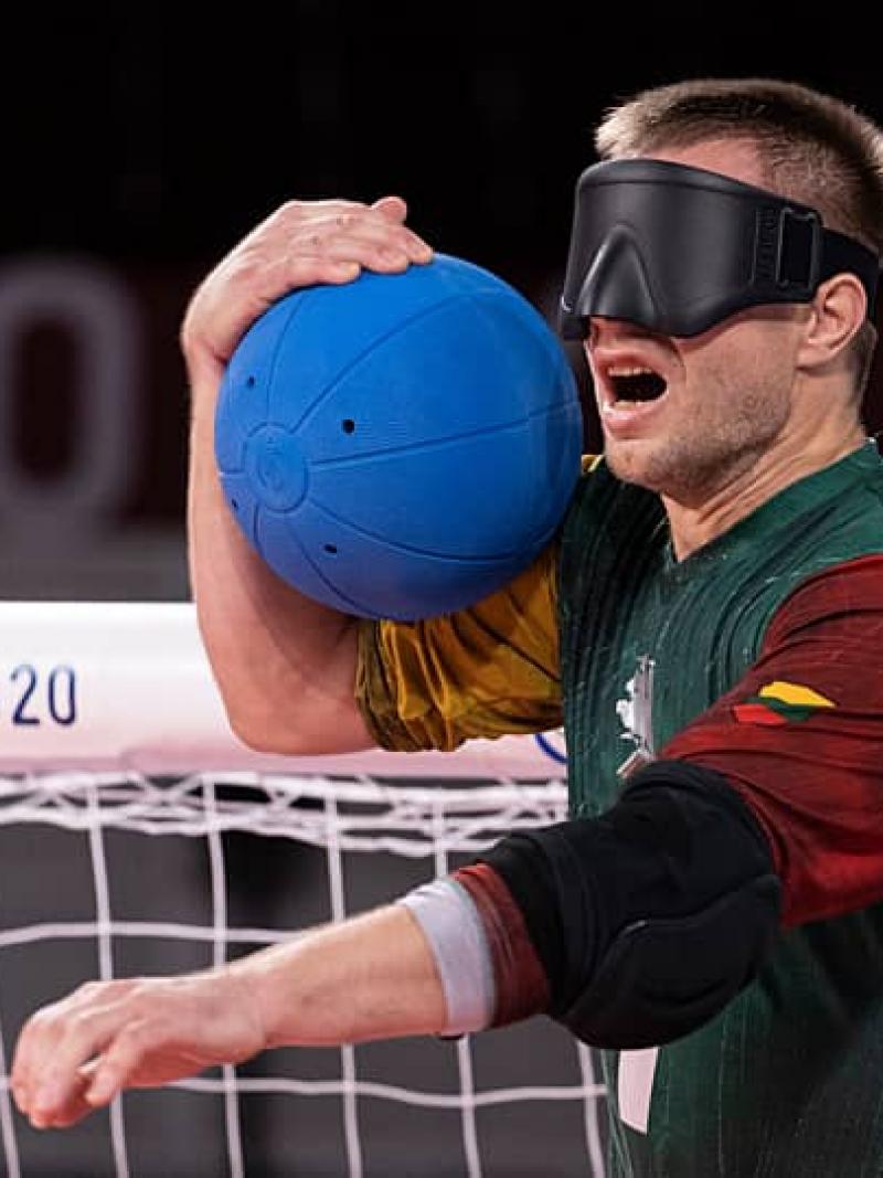 Goalball player Genrik Pavliukianec calling out while holding the ball 