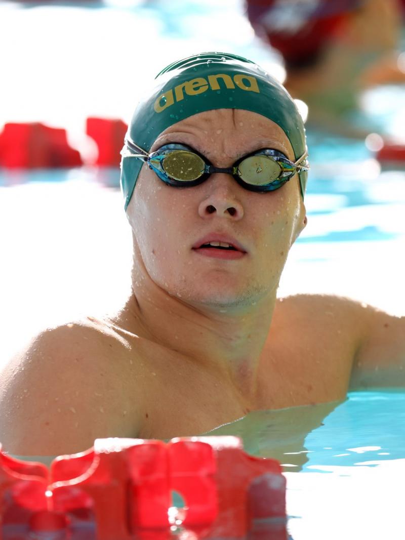 A male swimmer with his head outside the water