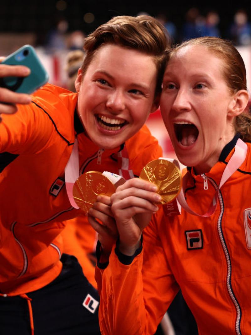 Two Dutch women's wheelchair basketball players take a selfie with their gold medals.