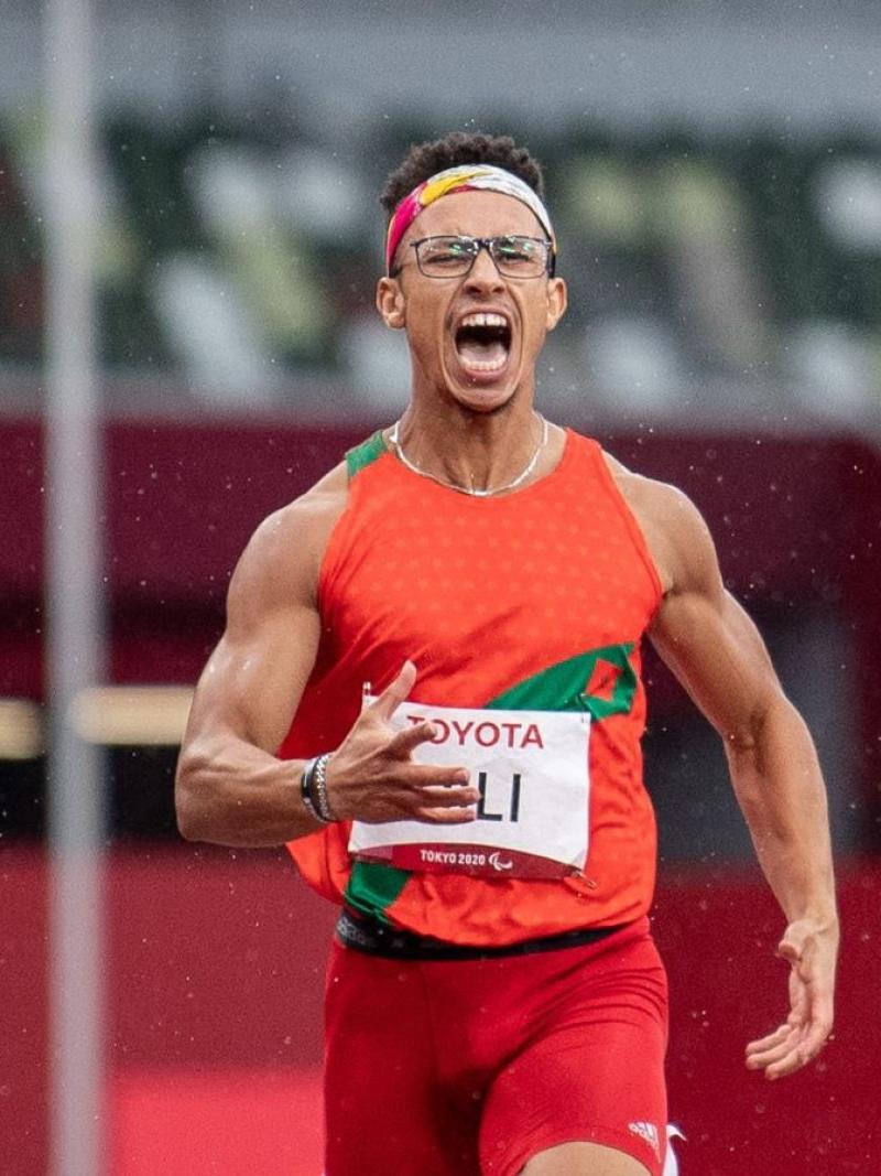 A male runner shouting in a stadium