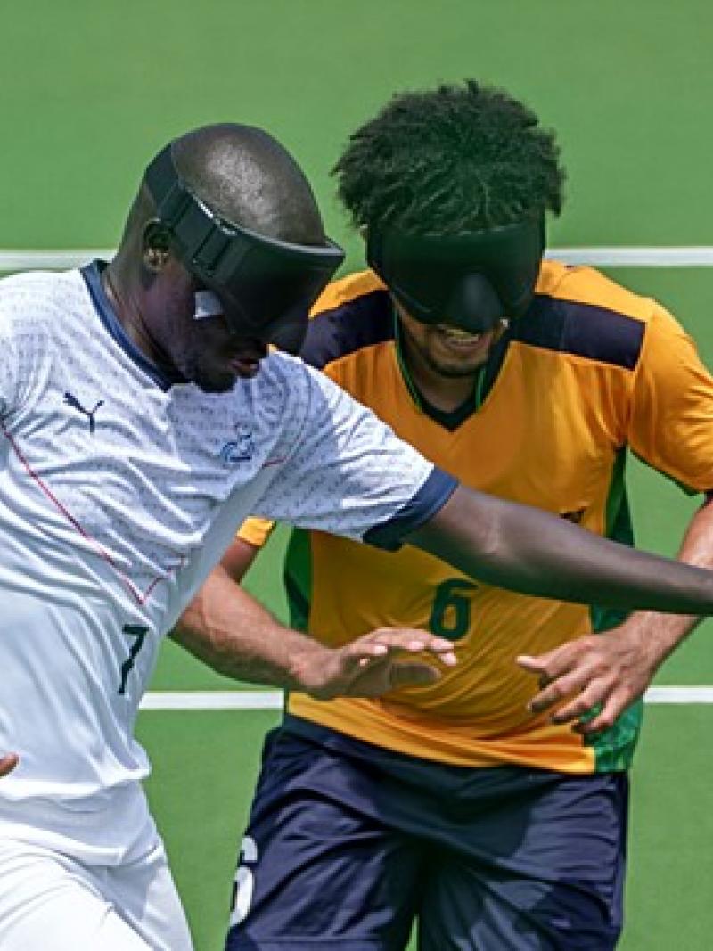 blind footballer Babacar Niang holds off another player from the ball 