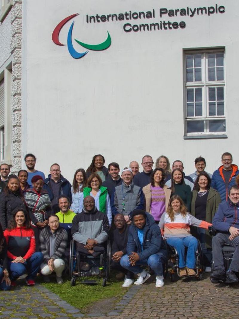 About 60 IPC staff pose for a photo in front of the IPC headquarters in Bonn.
