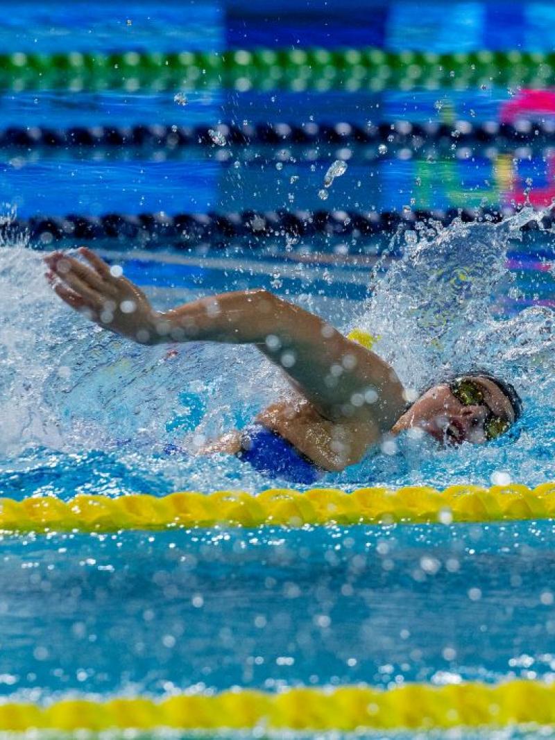A female swimmer competing in a pool
