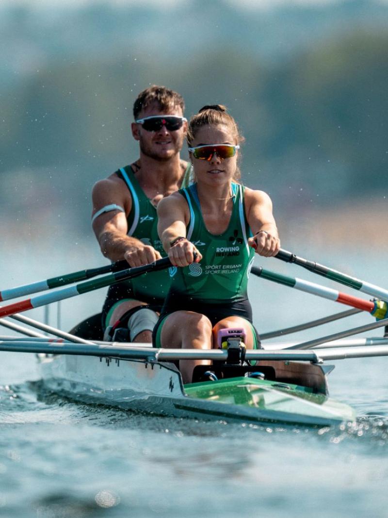 A female and male Para rowers competing.