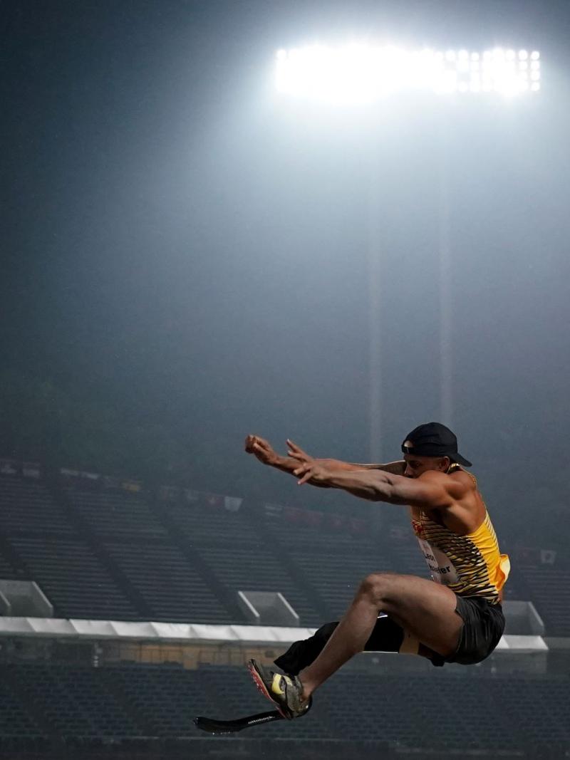 A man with a prosthetic leg in a long jump competition