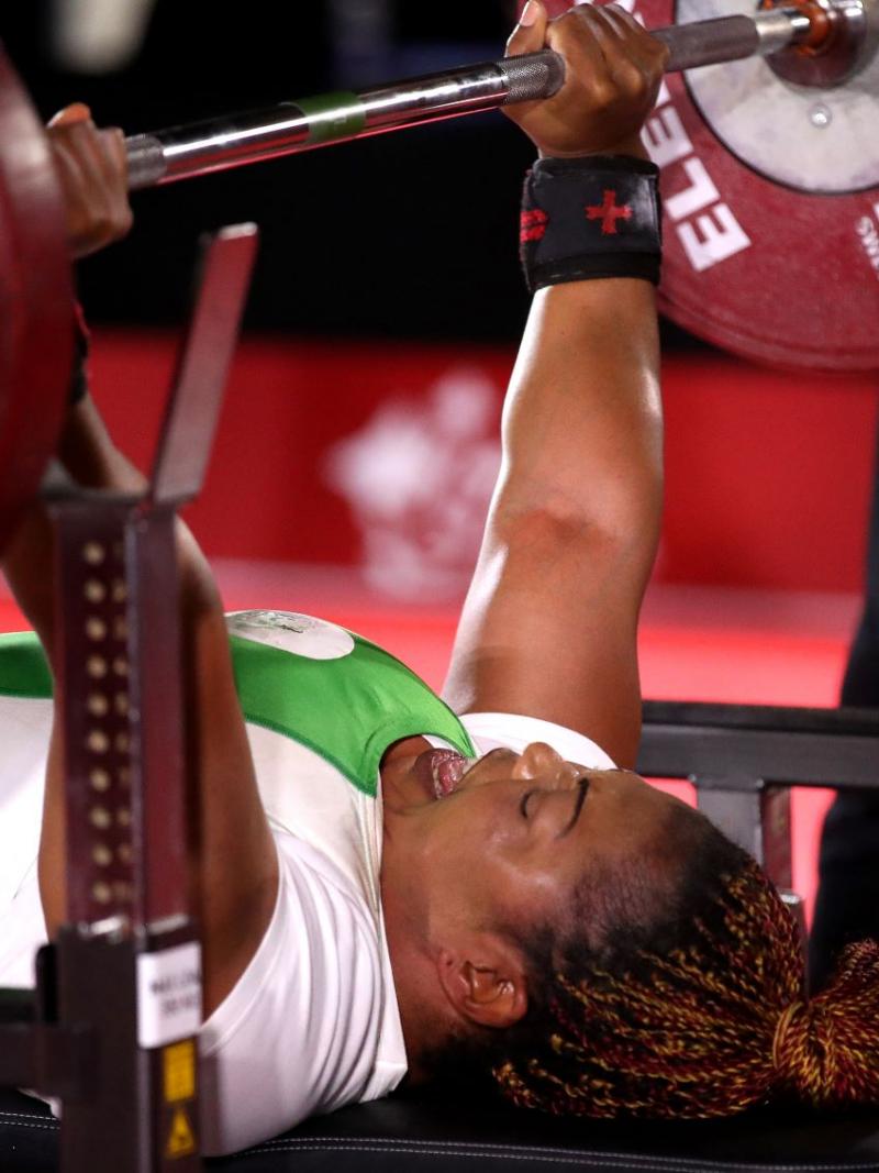 Lucy Ejike of Nigeria lifts weights during competition