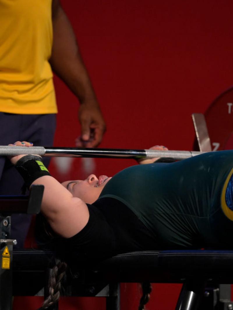 A female athlete lifts weights
