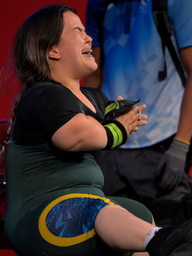 A female Para powerlifter reacts after a lift.