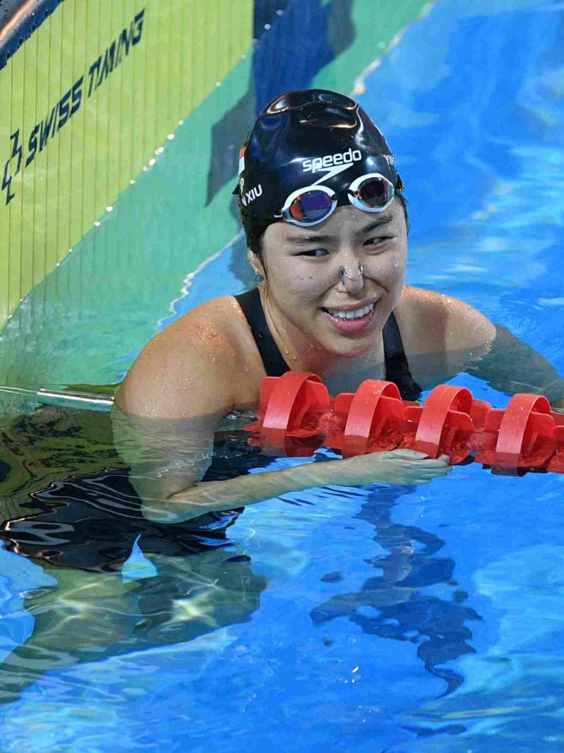 A swimmer reacts after her performance