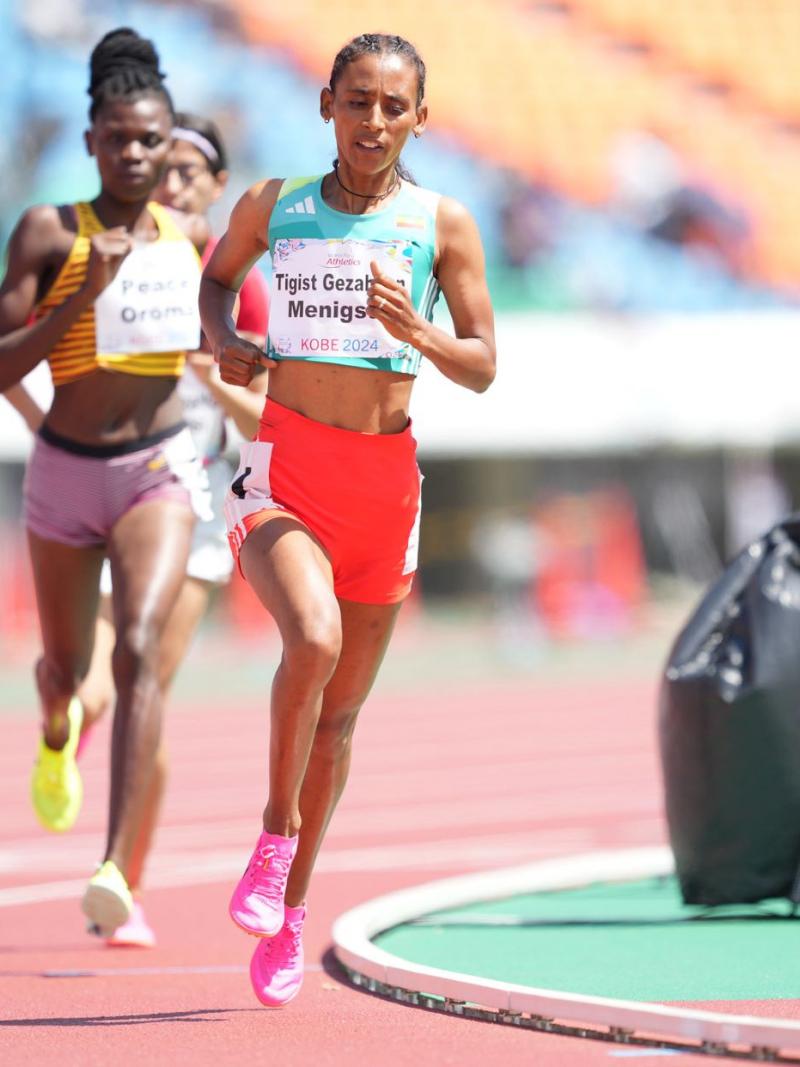 A female runner ahead of two competitors