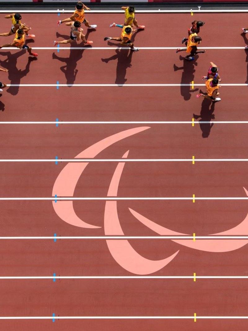 Overhead photo of athletes and their guides running on the track.