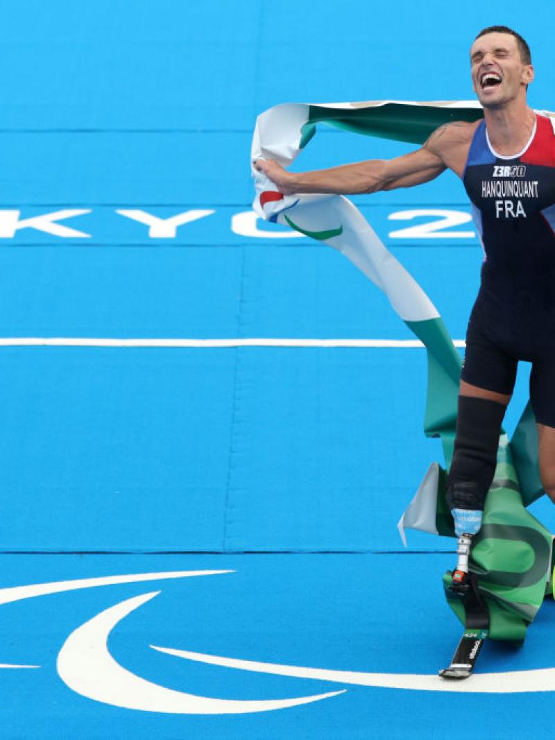 A male triathlete reacts after winning his race at the Tokyo 2020 Paralympics