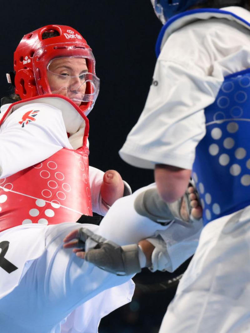 A female athlete kicks her opponent