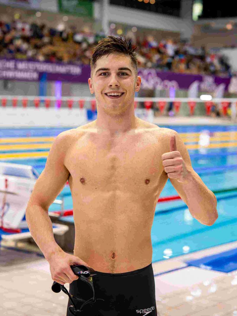 A swimmer gestures after his race