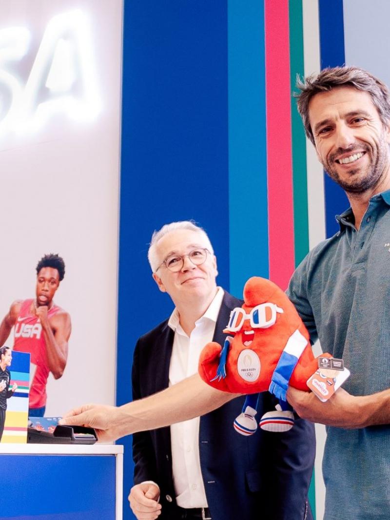 Paris 2024 President Tony Estanguet poses for a photograph while holding the Games mascot Phryge at the megastore