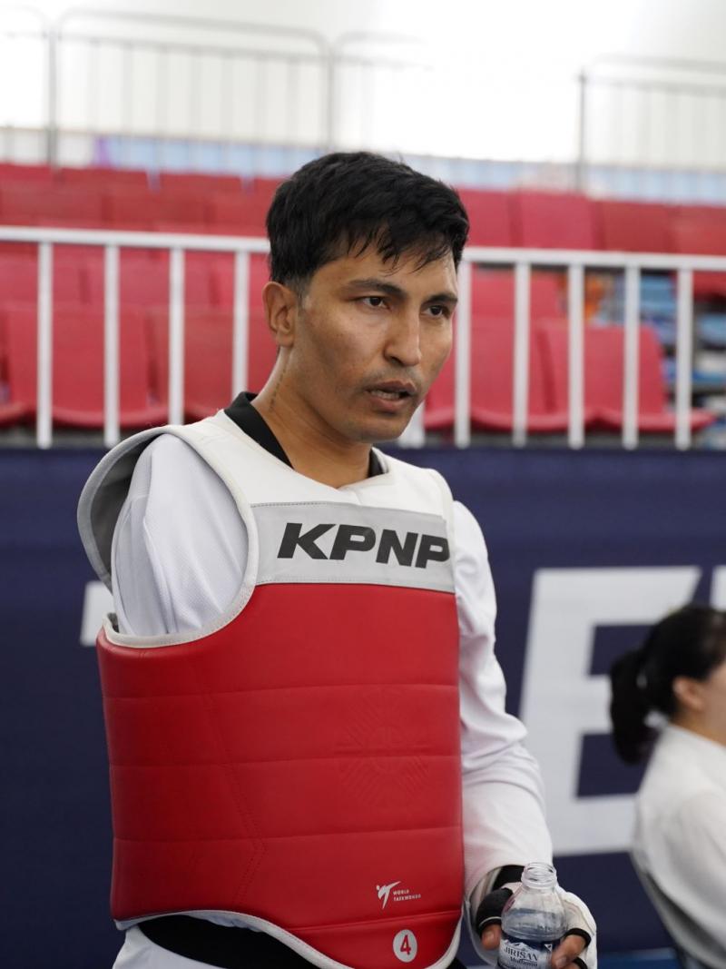 Hadi Hassanzada, a member of the Refugee Paralympic Team at Paris 2024, is photographed wearing the taekwondo gear.