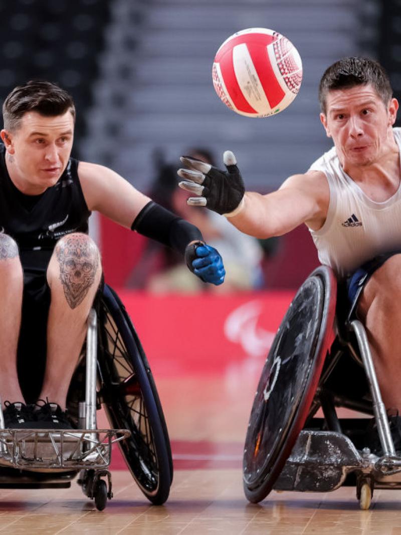 Two male wheelchair rugby players in action