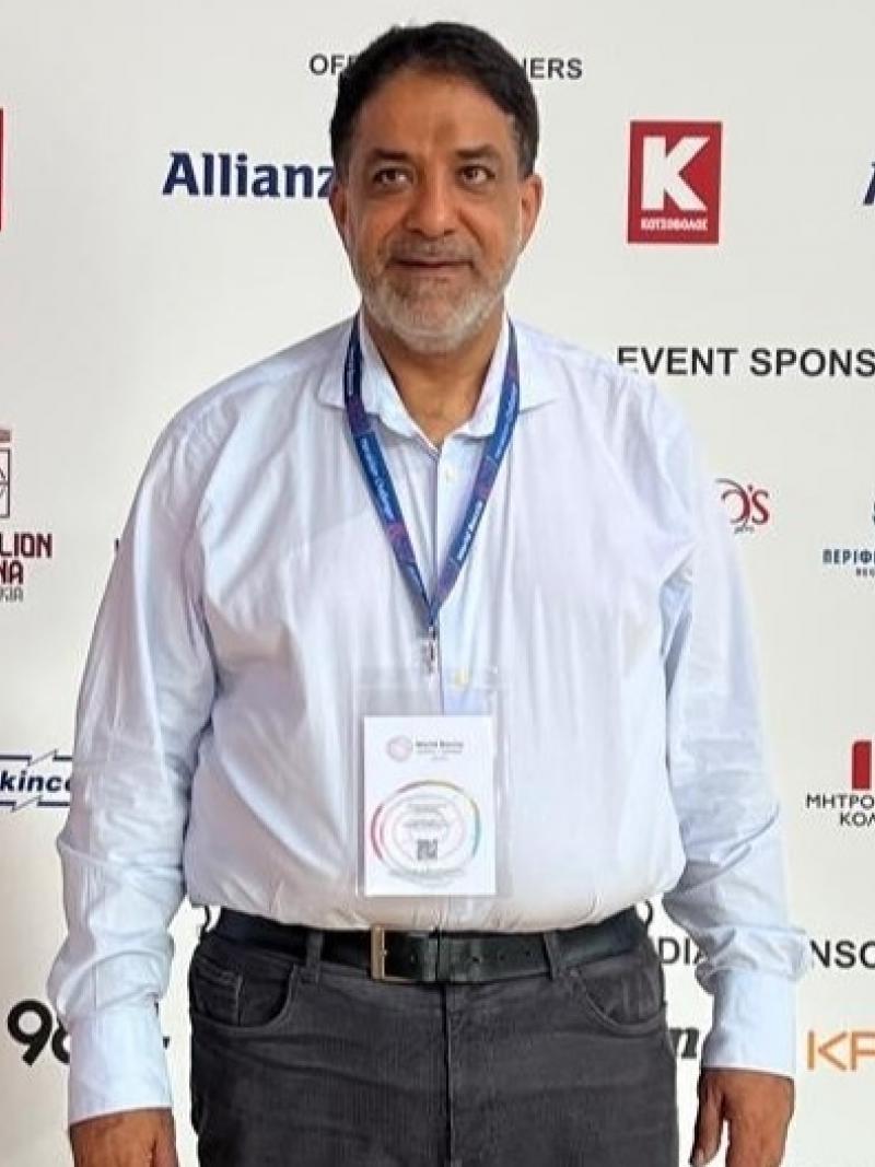A man standing with backdrop behind him