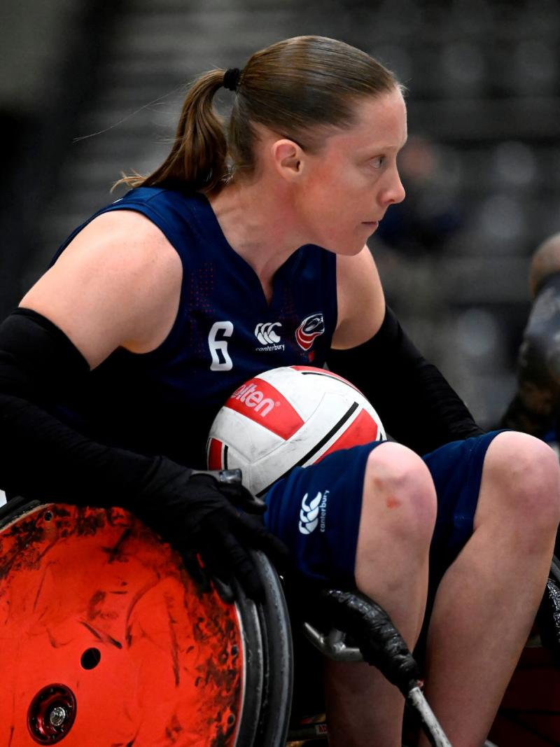 Sarah Adam carries the ball during a wheelchair rugby match